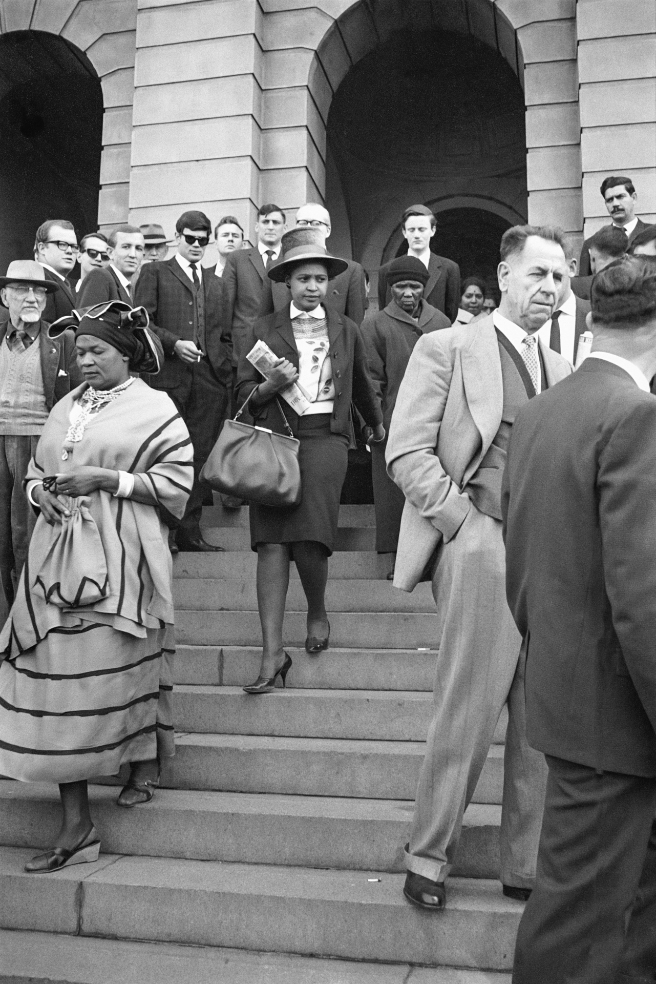 Albertina Sisulu, Winnie Mandela and Noqaphi Nosekeni (Nelson Mandela’s mother) descend the stairs of the court at the Rivonia Trial. © Alf Kumalo Estate