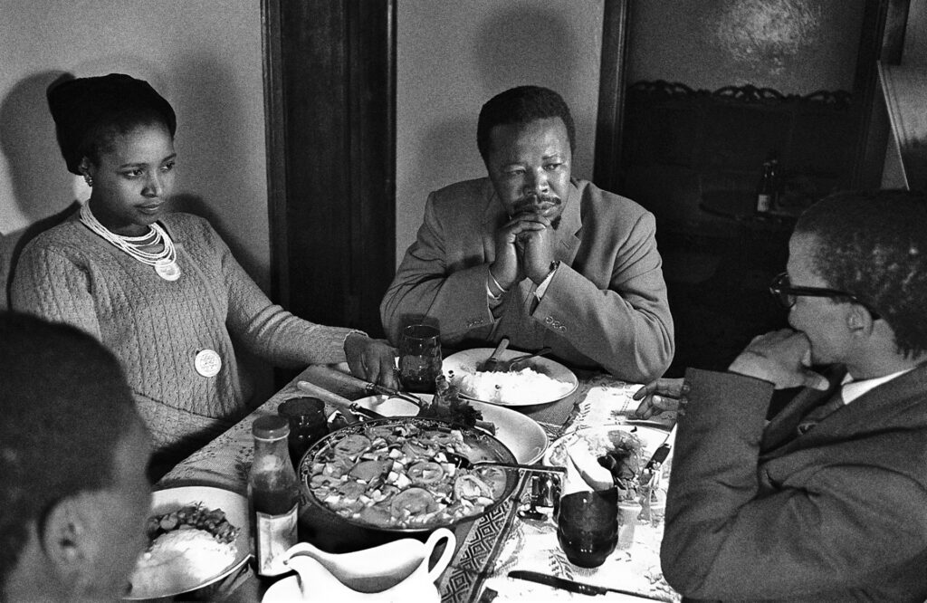 <p>Winnie Mandela eats with the Paramount Chief of the amaThembu, Sabata Dalindyebo, and journalist Harry Mashabela. <em>© Alf Kumalo Estate</em></p>
